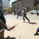 Zimbabwe police officers clash with protestors in Harare.